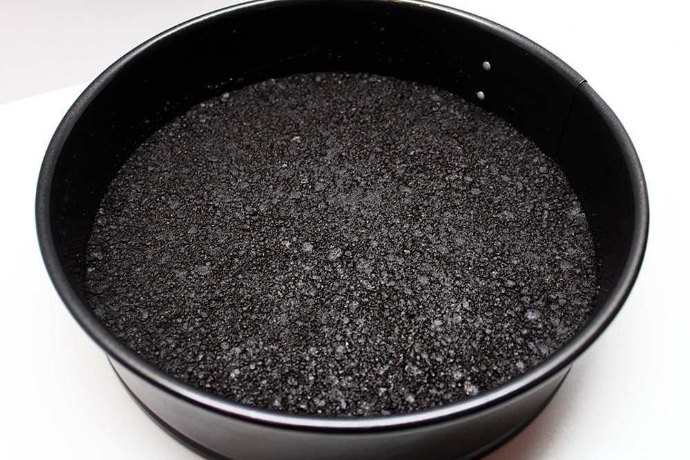 Oreo crust pressed onto the bottom of a springform pan.