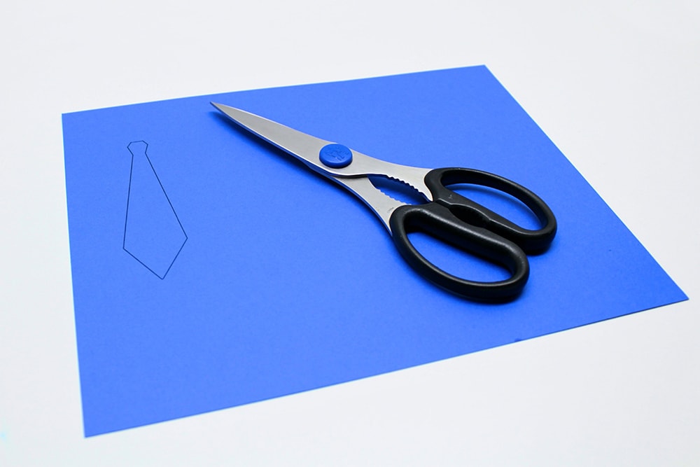 Tie template printed on dark blue cardstock.