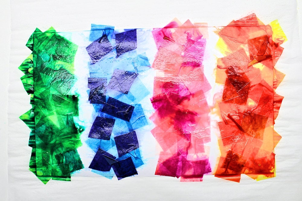 Wet tissue paper squares on a sheet of white cardstock.