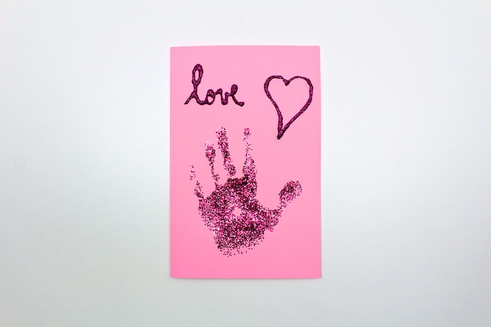 Finished pink card with glitter handprint.