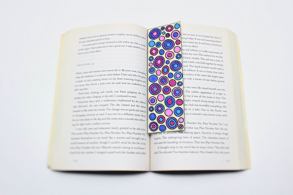 Abstract geometric bookmark in open book.