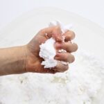 Child's hand holding fake snow.