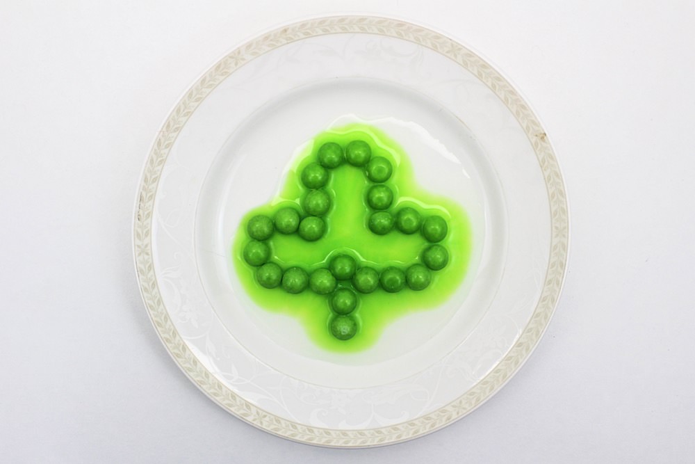 Skittles arranged in shamrock shape with bleeding green colour.