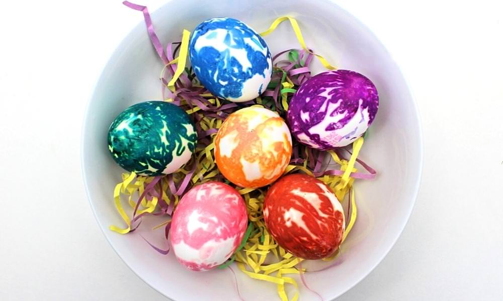 Bowl filled with tissue paper dyed Easter eggs