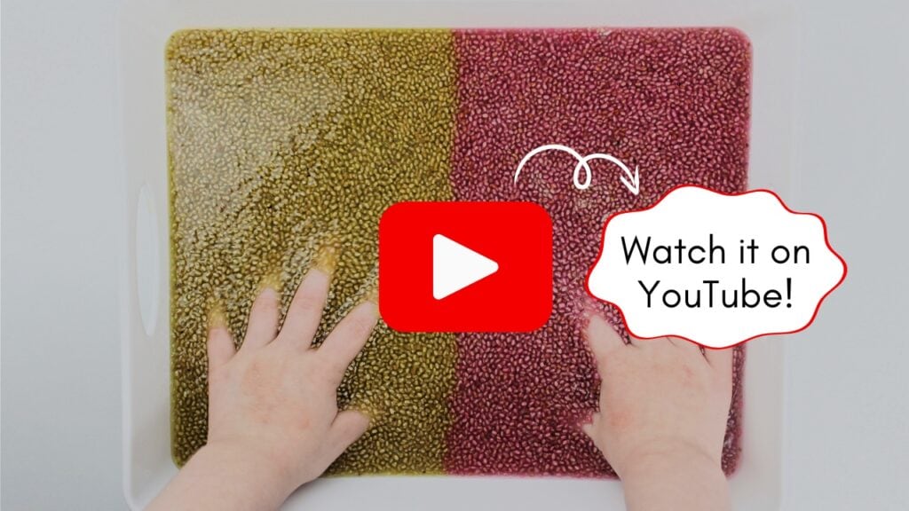 Image of a child's hands inside a chia seed sensory bin, with a button for watching the video on YouTube.