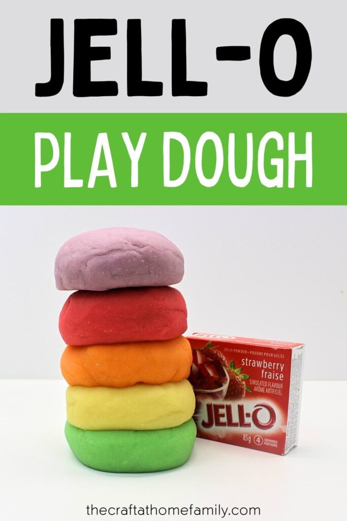 Stack of 5 colourful balls of play dough next to a box of strawberry Jell-O (with text overlay that says "Jell-O Play Dough")