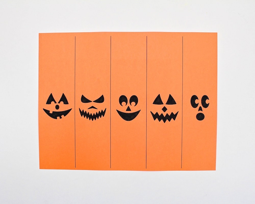 Pumpkin template printed on orange construction paper and coloured in.