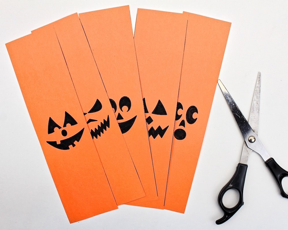 Pumpkin template cut into strips with scissors.