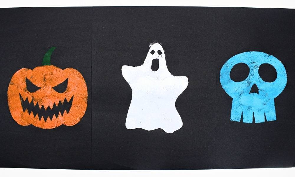 Sponge painted jack-o'-lantern, ghost and skull on black construction paper