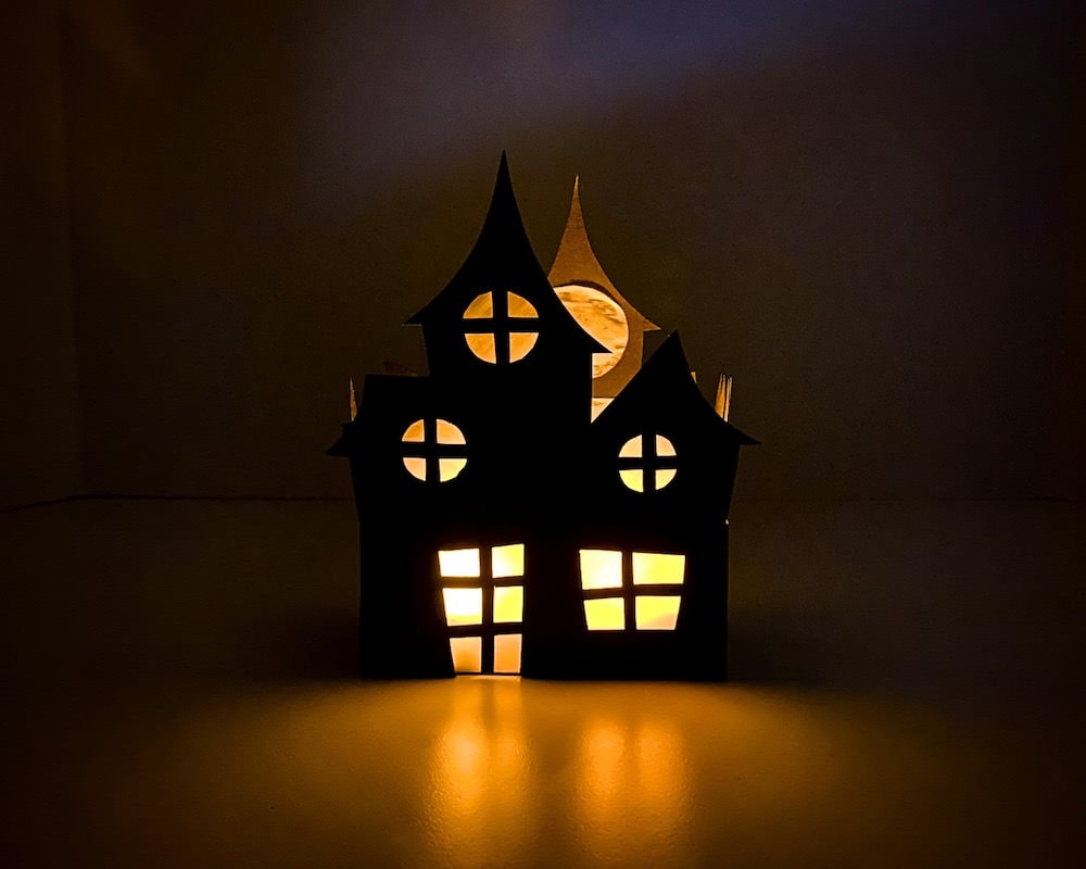 3D paper haunted lantern lit up in the dark.