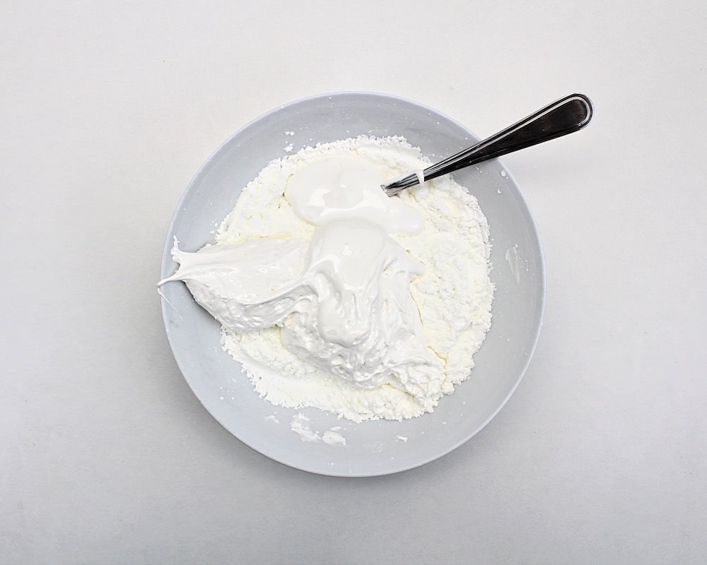Bowl with marshmallow fluff added to dry ingredients.