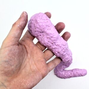 Hand holding oozing purple slime