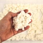 Hand holding a ball of white dough.