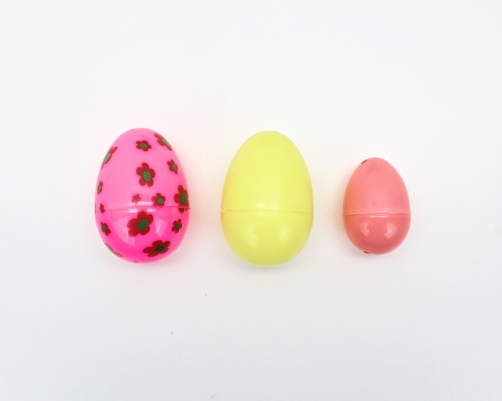 3 plastic Easter eggs side-by-side (2 large and 1 small).