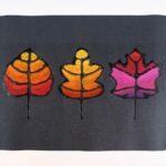 Colorful chalk pastel leaves on black paper.