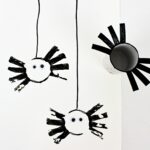 Paper roll stamp spider craft next to paper roll spider stamp.