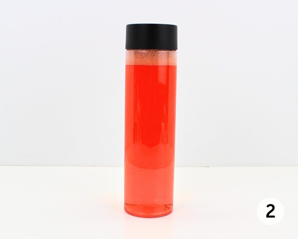 Bottle filled with red liquid.