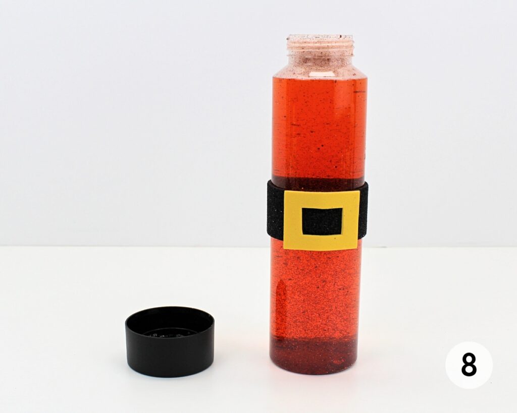 Red glitter bottle filled with liquid.