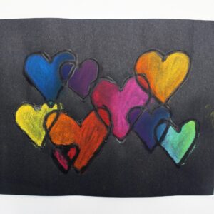 Colorful overlapping heart craft on black paper.