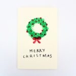 Homemade card with painted Christmas wreath.