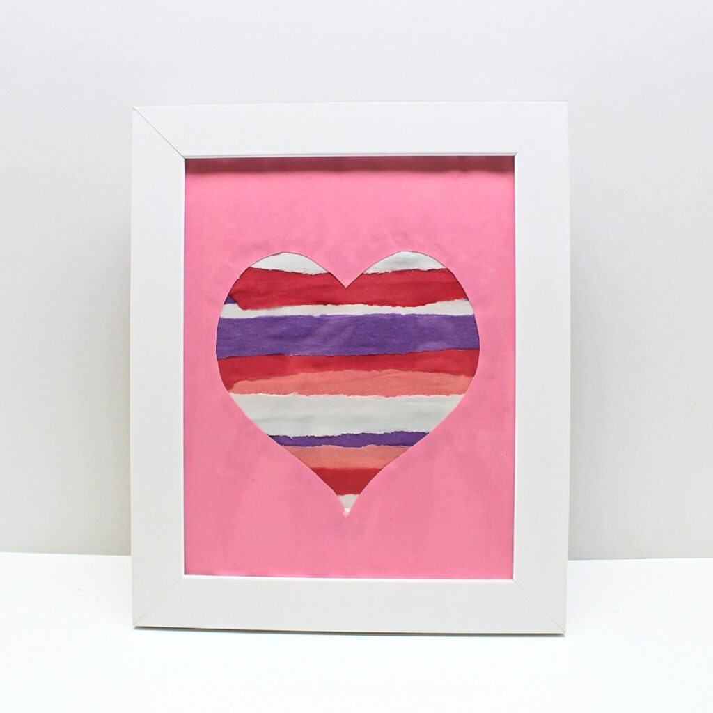 Heart craft made with torn strips of construction paper.