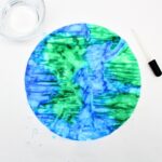 Blue-and-green colored coffee filter with water added.