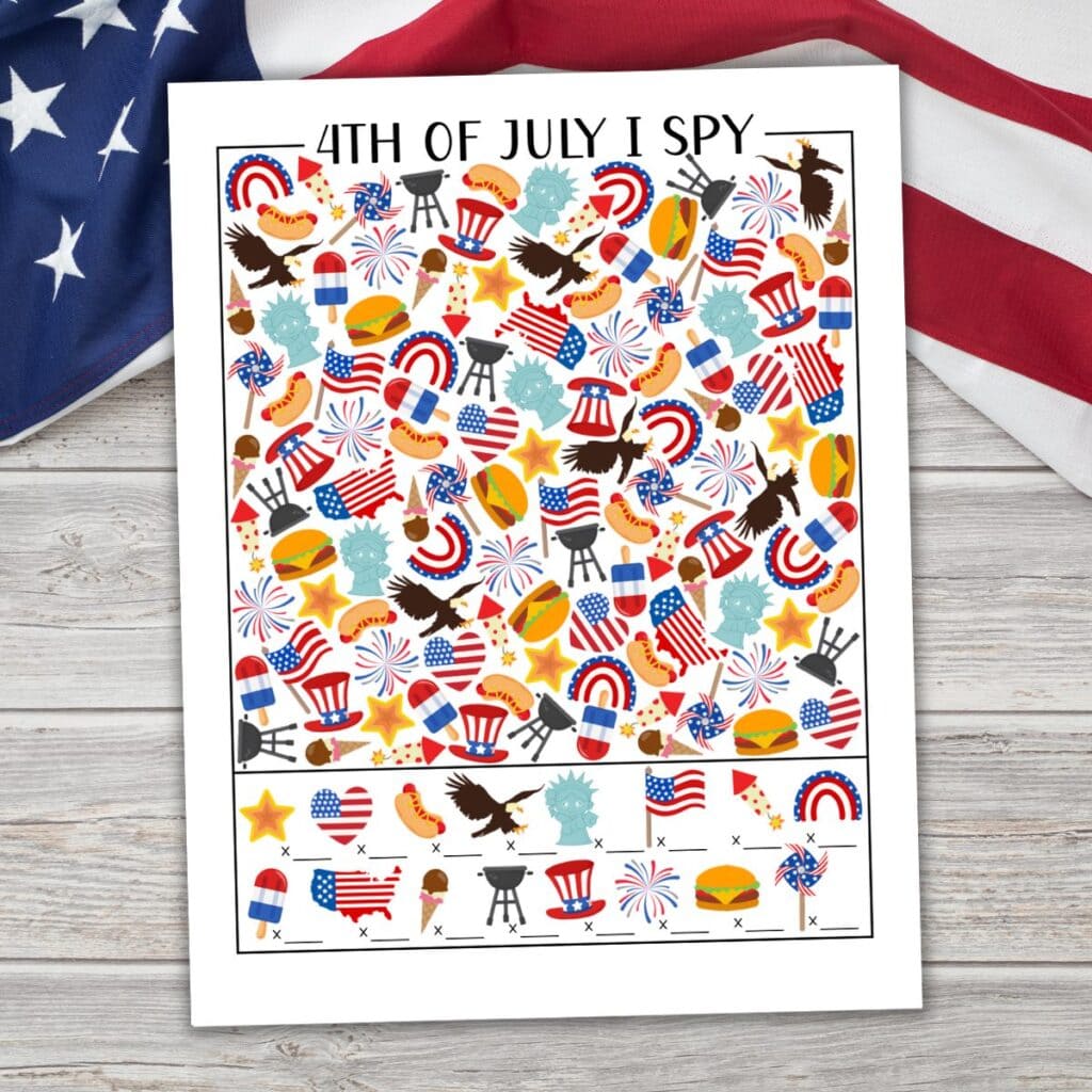 Mockup of 4th of July I Spy printable on a realistic background with a U.S. flag.