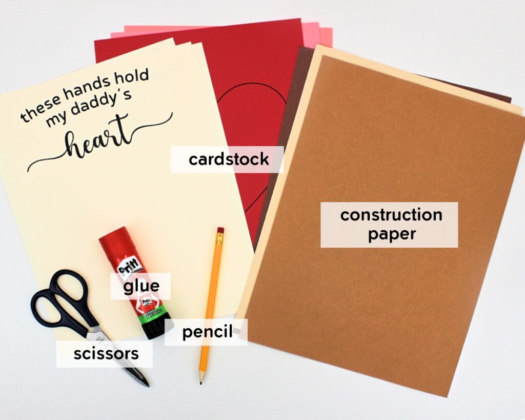 Materials to make a "hands holding heart" craft.