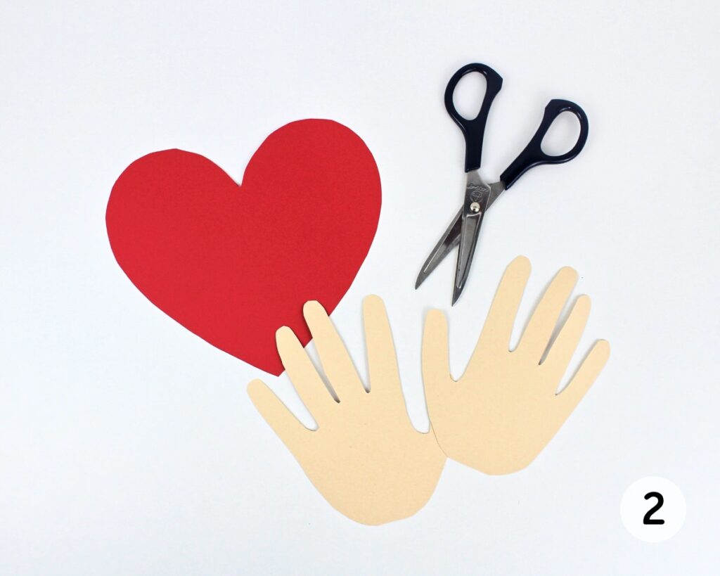 Large heart an child's handprints cut with scissors.