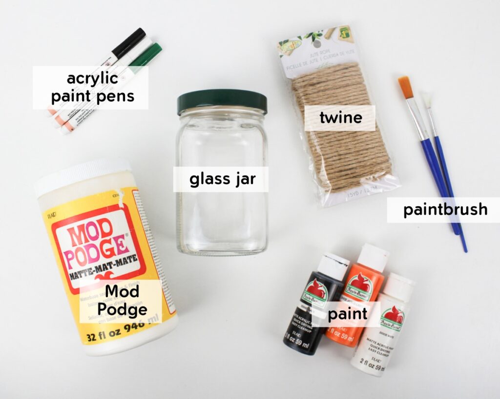 Supplies to make a Halloween candle holder from a glass jar.