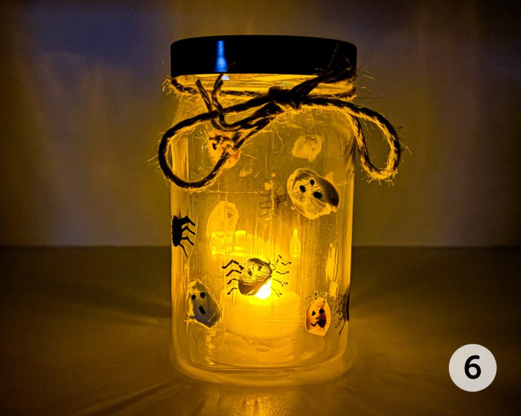 Candle holder glowing in the dark, with a battery-operated tea light inside.