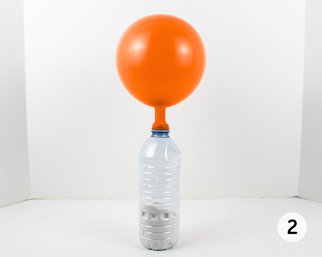 Flour-filled water bottle with an orange balloon attached to the top.