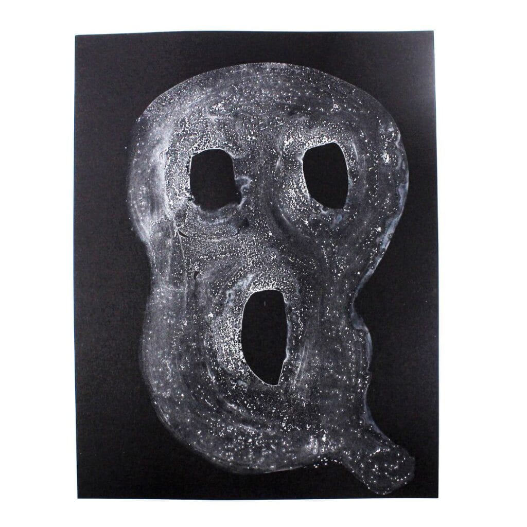 Textured white ghost on black cardstock.