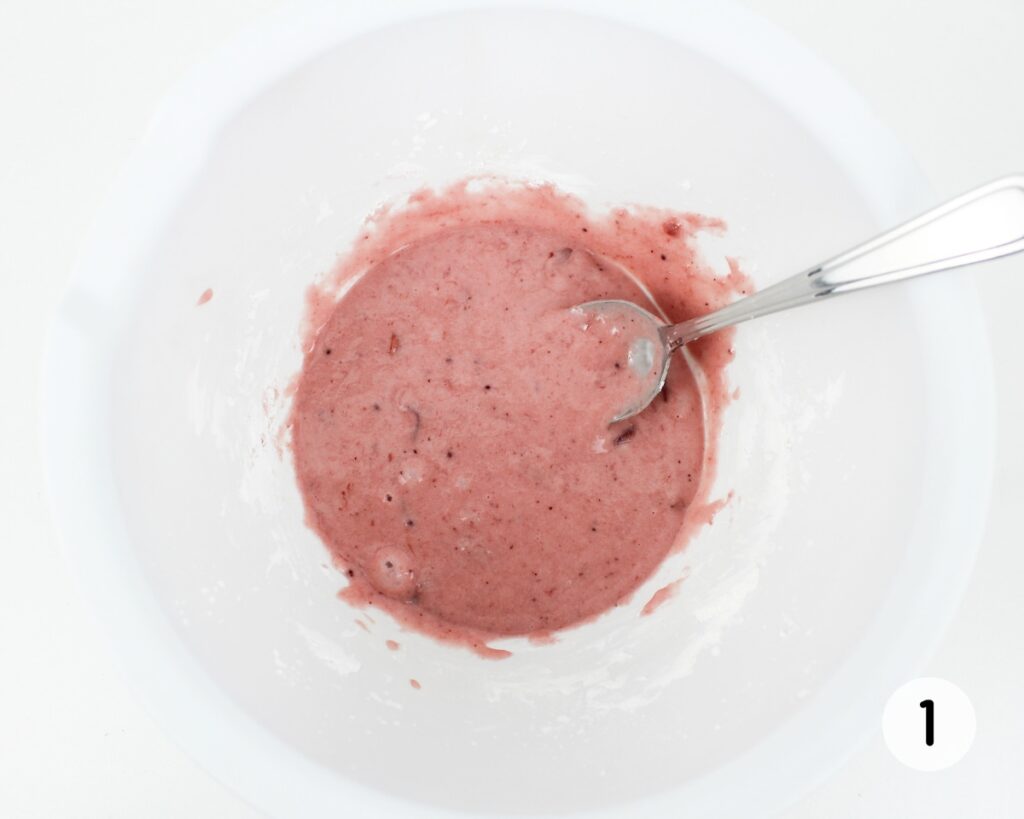 Pink mixture in white mixing bowl.