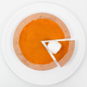 Paper plate pumpkin pie craft with cotton ball whipped cream.