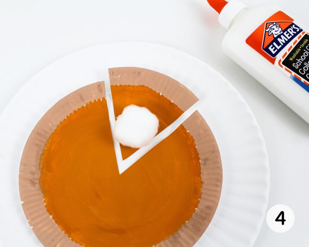 Cotton ball glued to pumpkin pie craft.