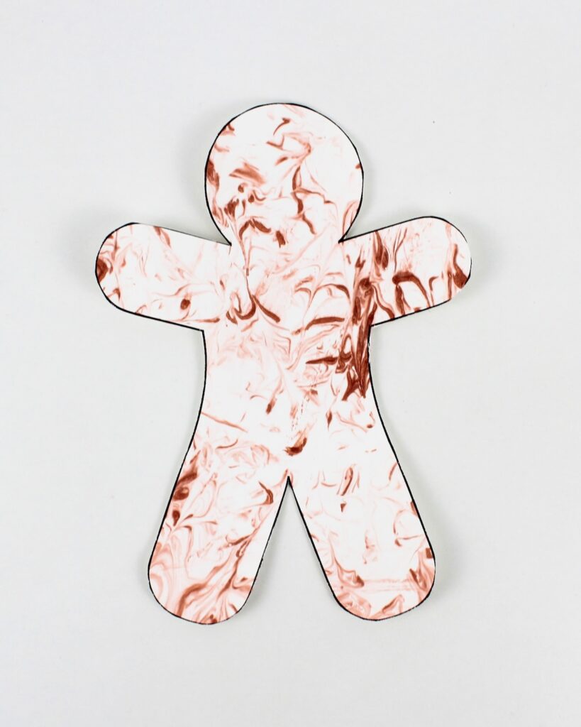 Gingerbread man craft with marbled patterns.