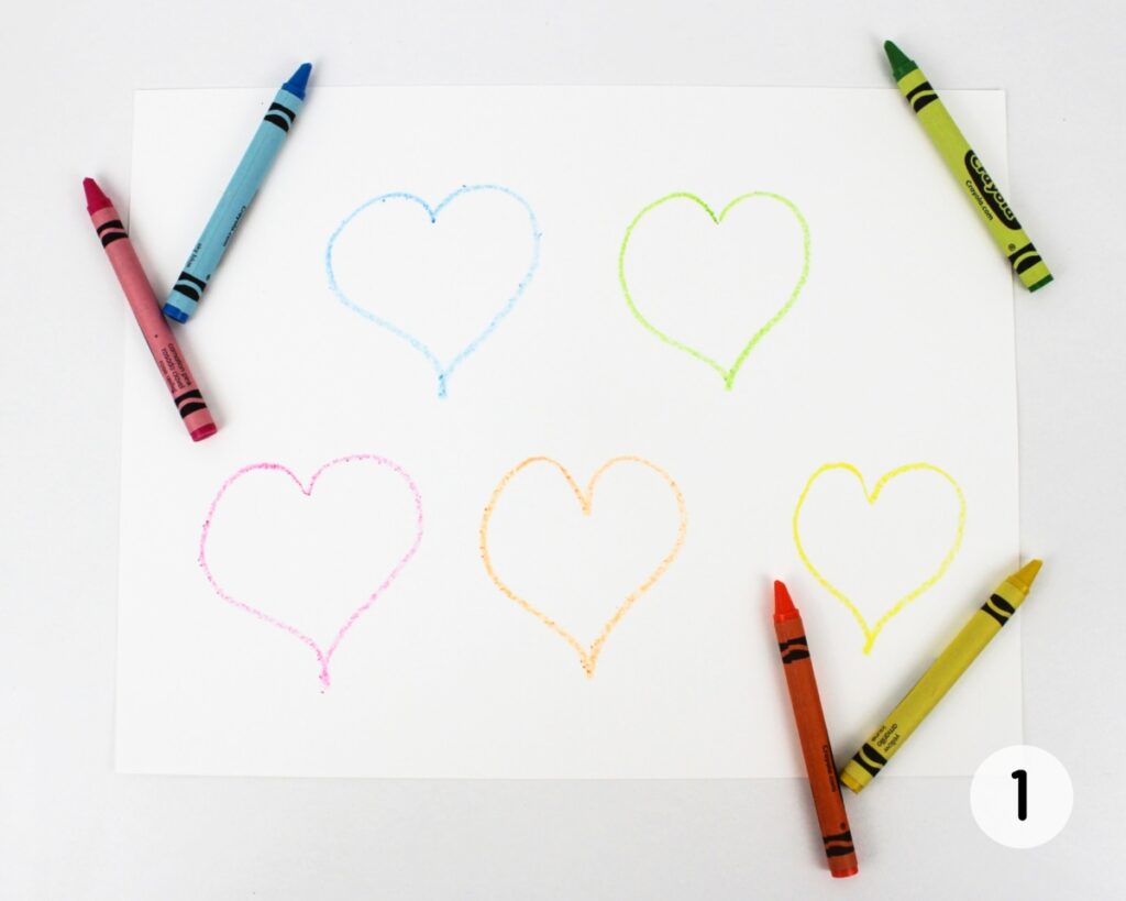 5 heart outlines drawn on a sheet of white cardstock.