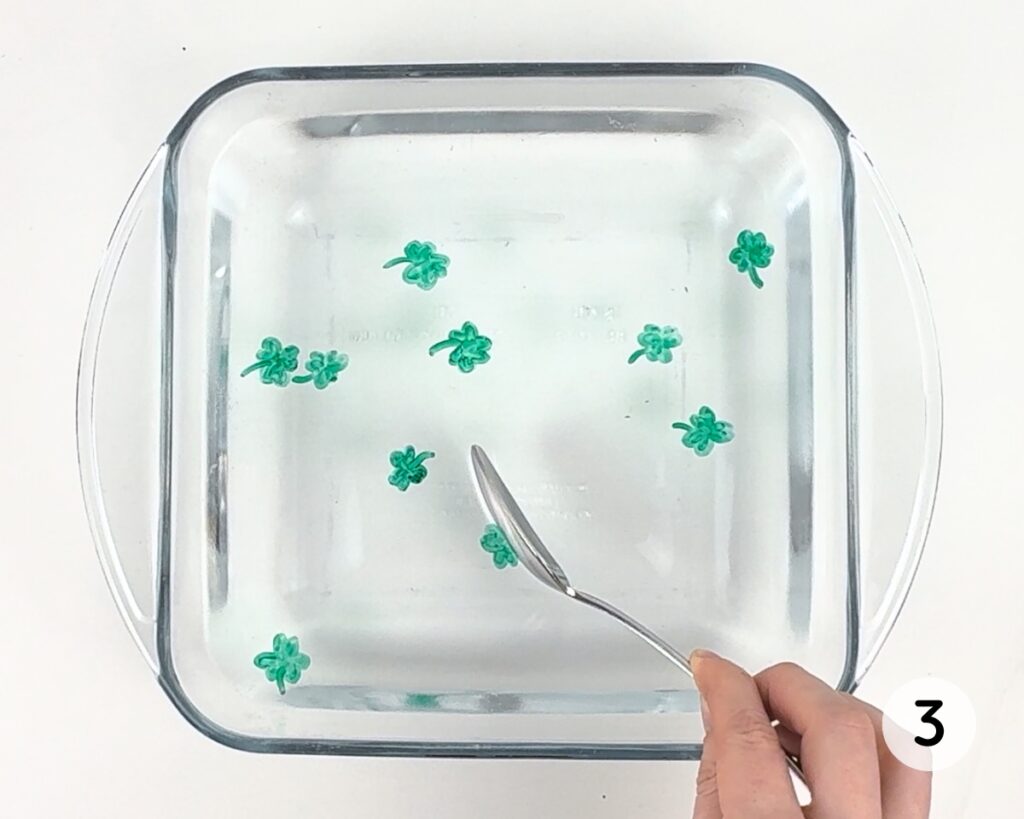 Dish filled with floating shamrocks.