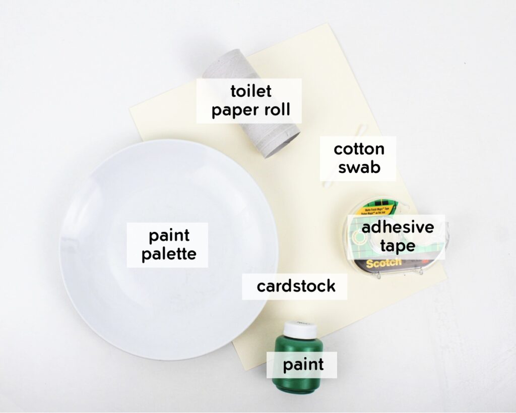 Supplies to make paper roll stamped shamrocks.