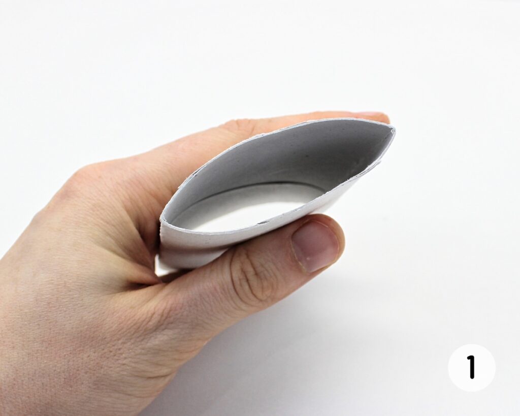 Hand folding a paper roll in half.