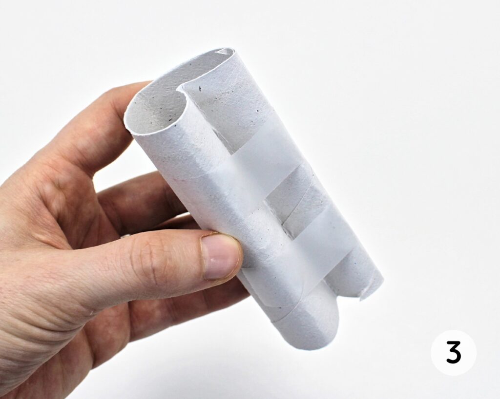 Paper roll heart stamp secured with adhesive tape.