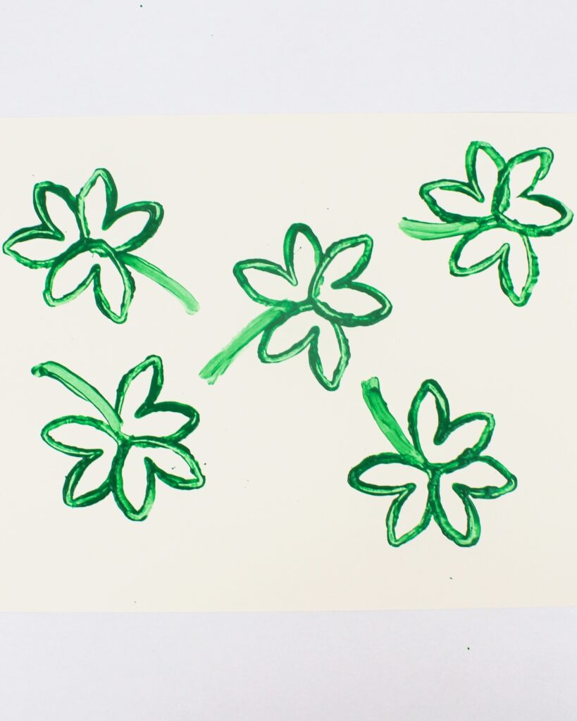 Finished paper roll stamped shamrock craft.