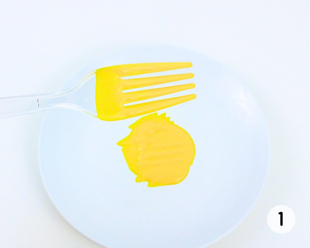 Plastic fork covered with yellow paint.