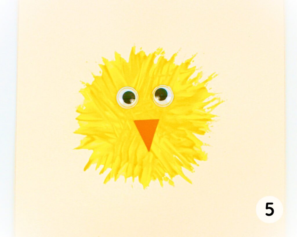 Yellow fork painted chick body with googly eyes and beak.