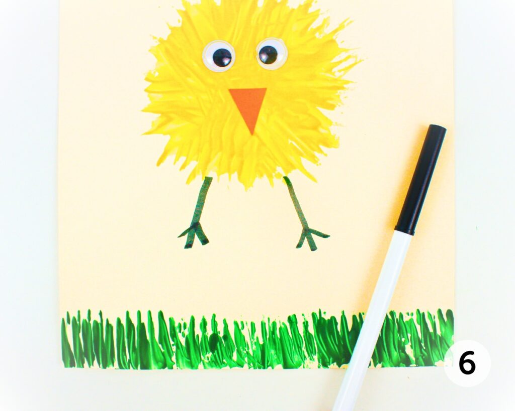 Fork painted Easter chick with legs drawn in black marker.