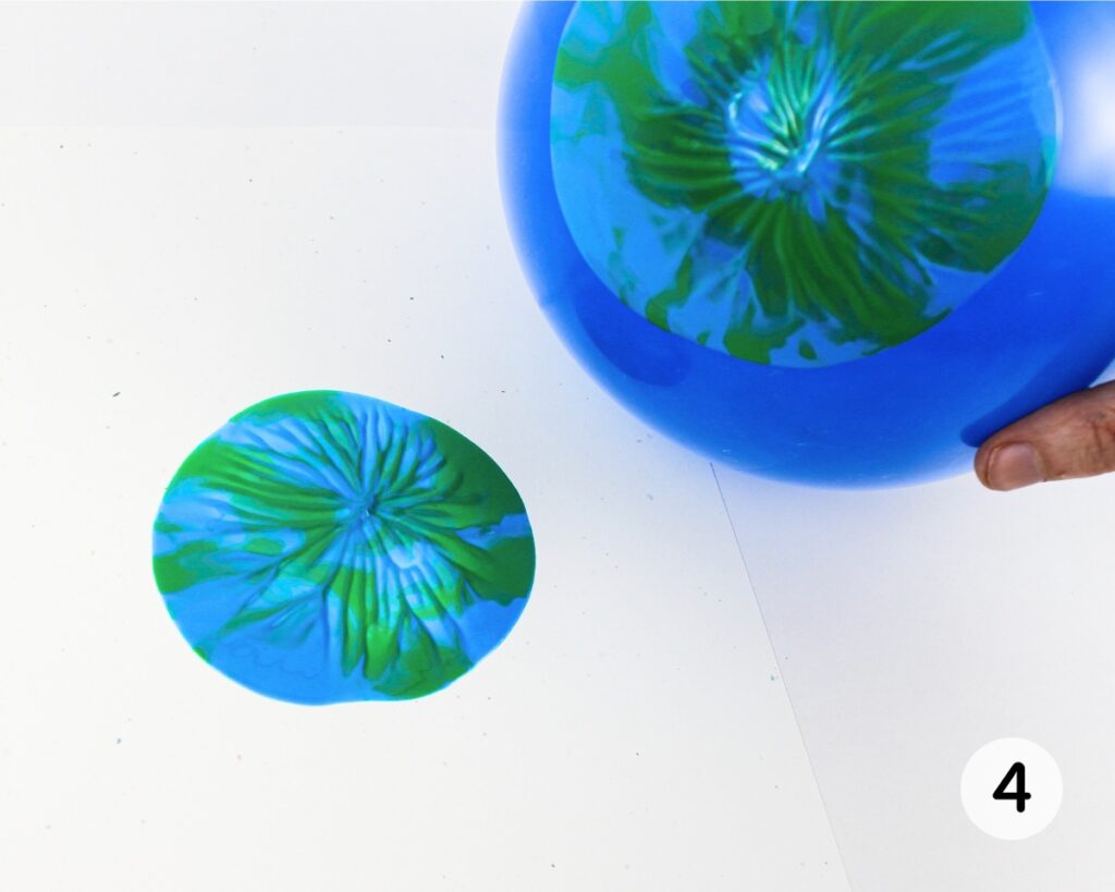 Blue and green Earth print on cardstock, made with a balloon.
