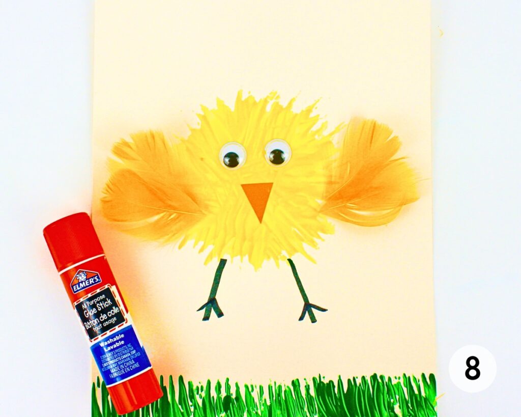 Fork painted chick with yellow feathers glued to either side.