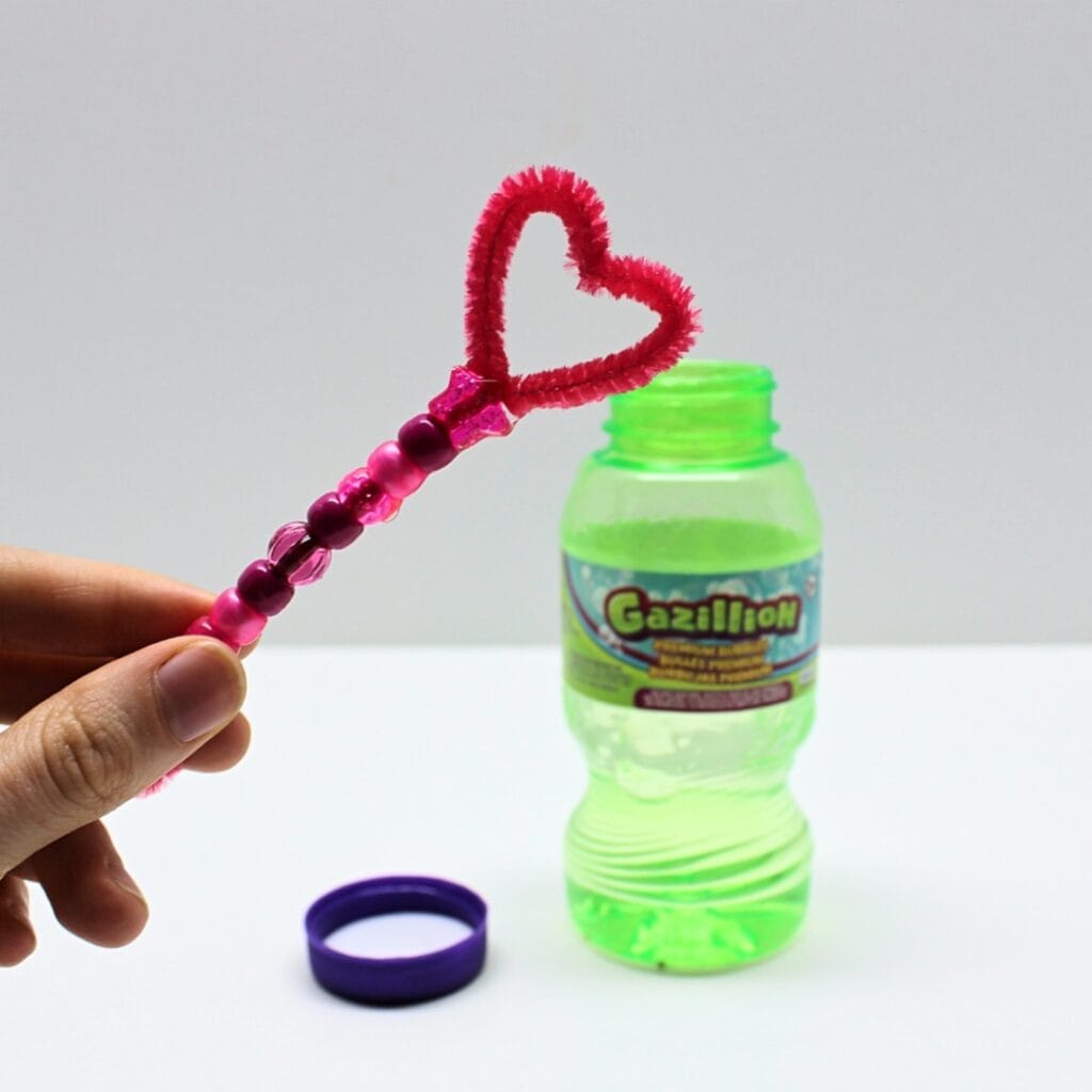 Hand holding a homemade bubble wand.