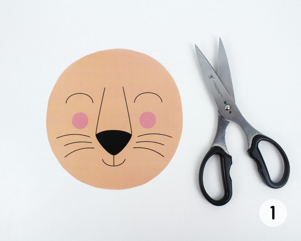 Lion face template cut out with scissors.